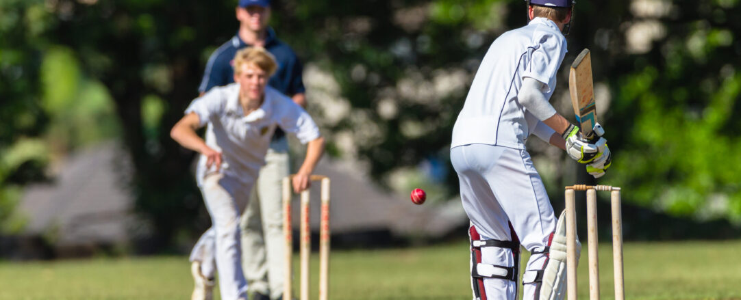 Cricket game teenagers schools game batsman bowler action photo.