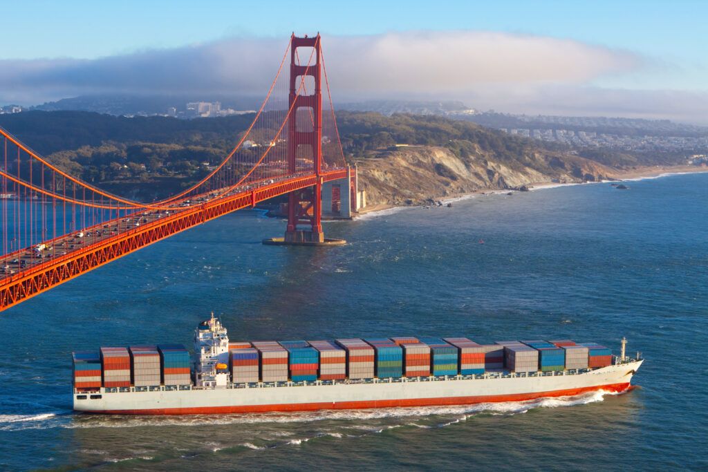 Container cargo ship under Golden Gate bridge Cargo container ship sailing under the Golden Gate Bridge, San Francisco