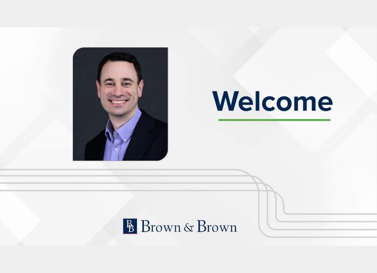 A headshot image of Corey Lewis on a Brown & Brown 'welcome' banner.