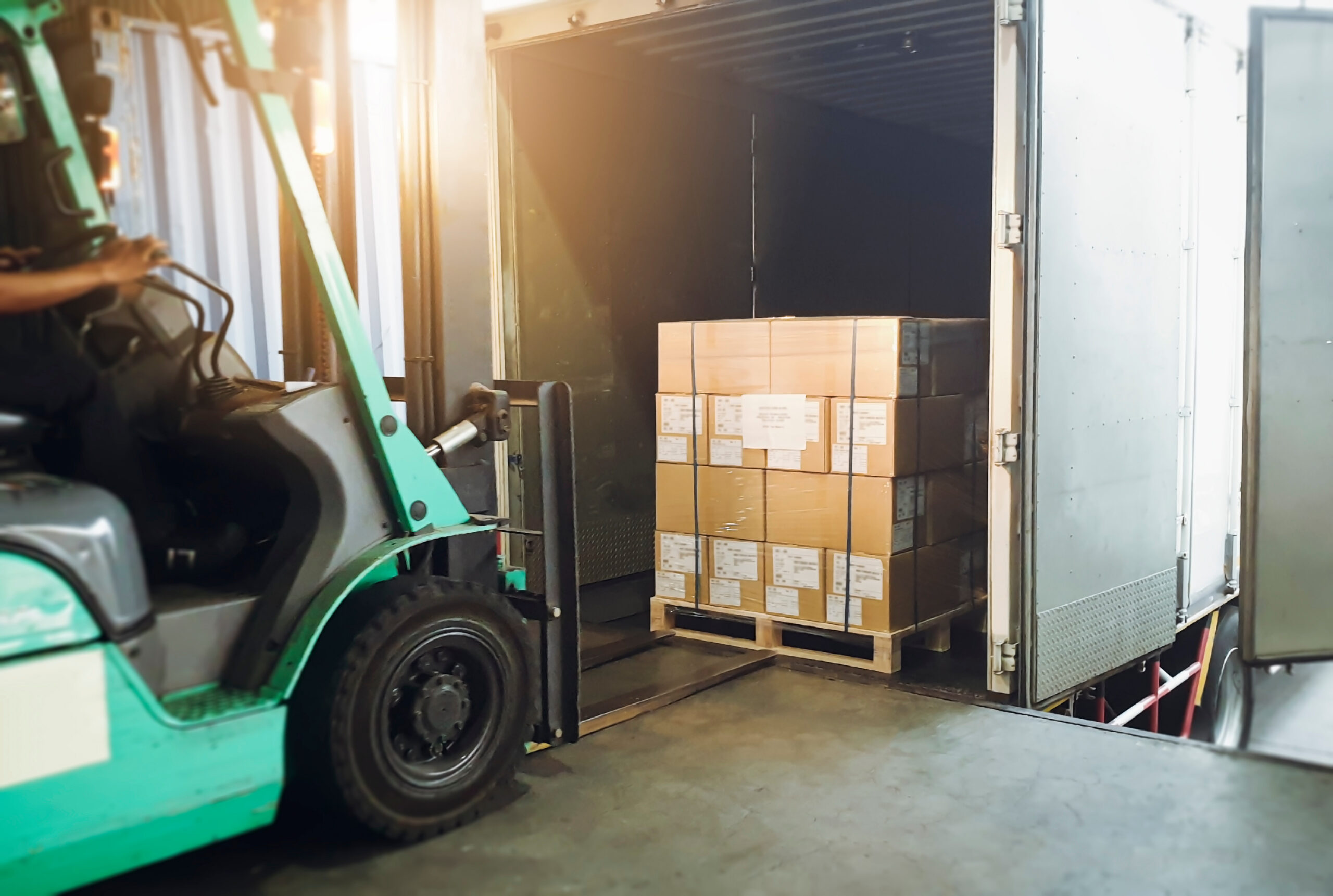 fork-lift-loading-trailer Fork lift loading pallet of cardboard boxed into trailer