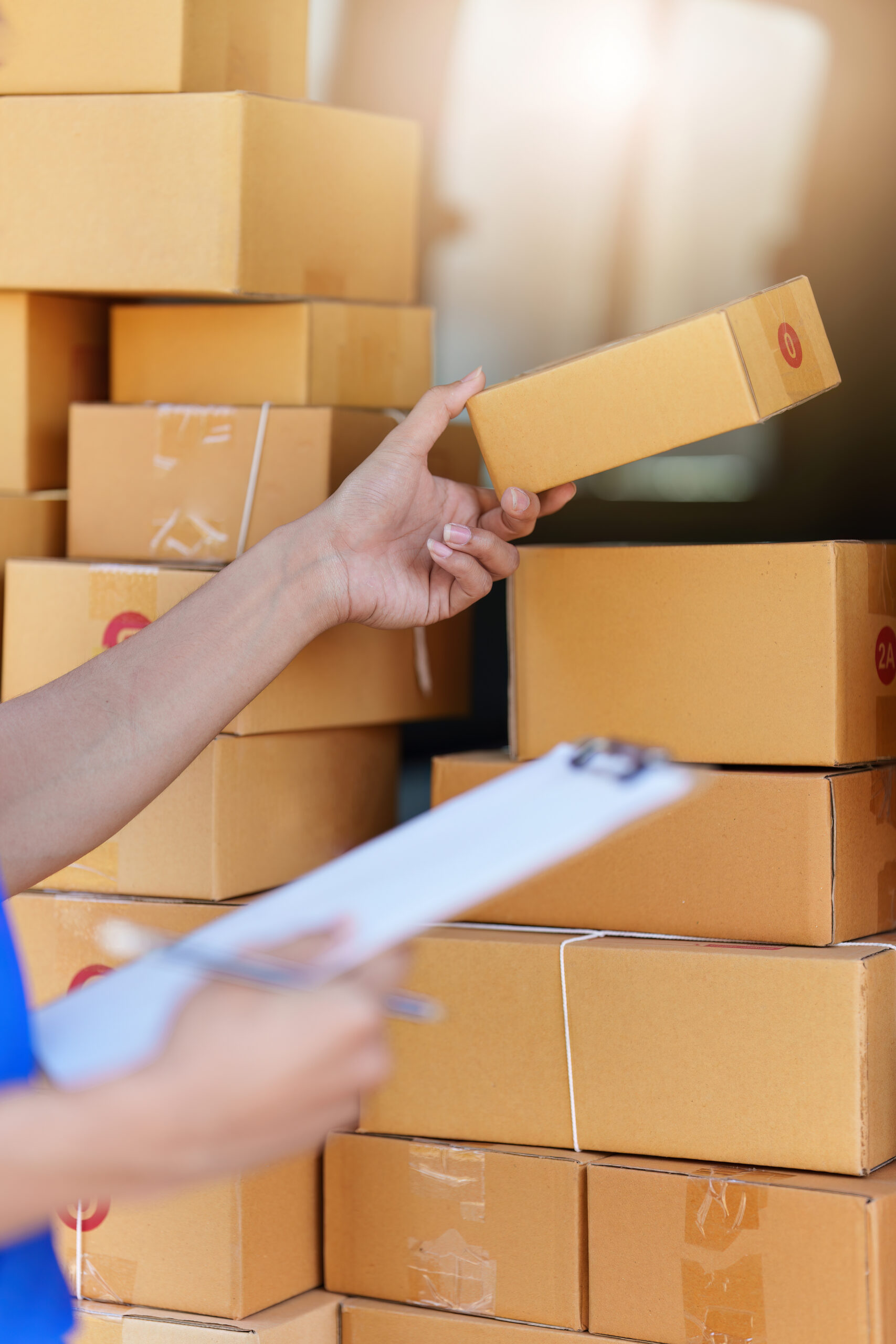 Courier with parcels inside delivery van and checklist