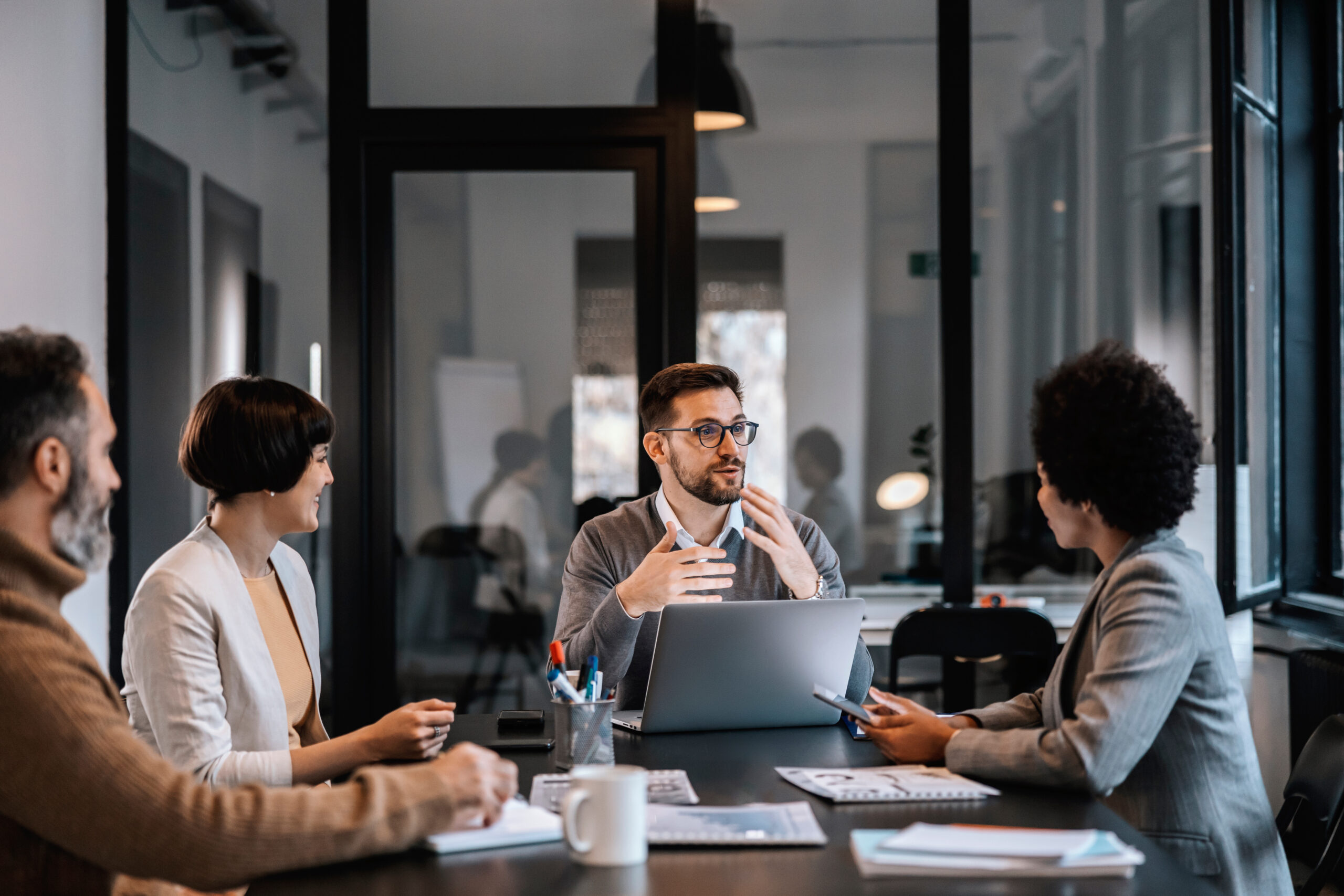 Colleagues having a discussion in a boardroom meeting office boardroom meeting