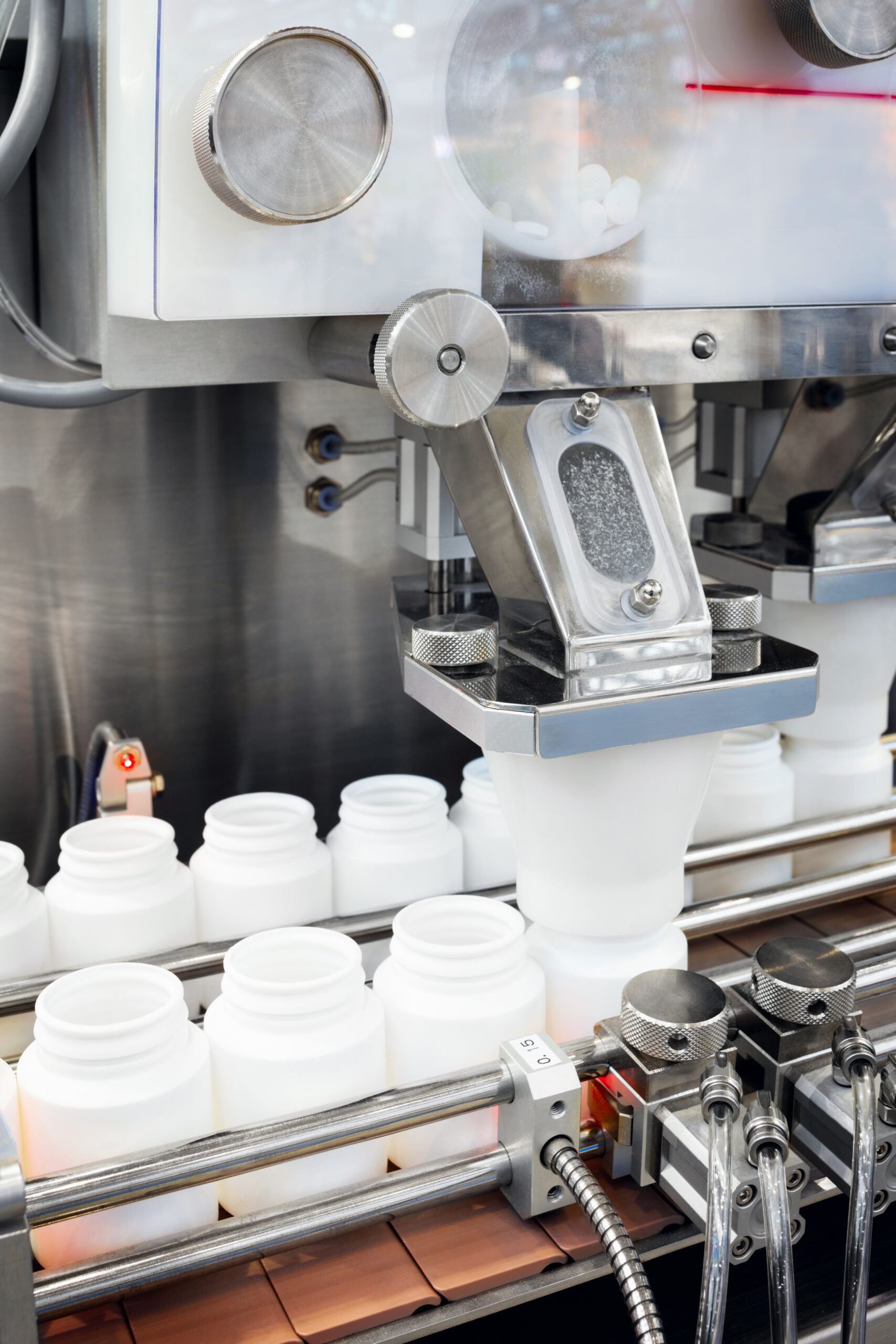 supplement pills are filling in the plastic bottle on production line