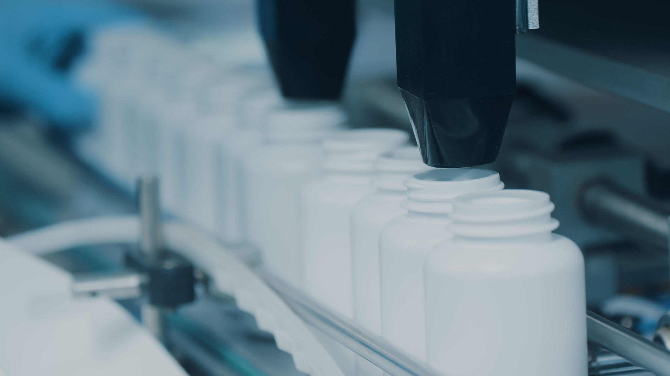 Supplement pill containers filled on conveyor