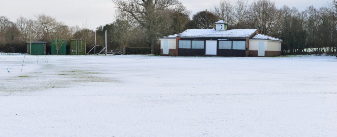 A cricket field covered in snow in winter.